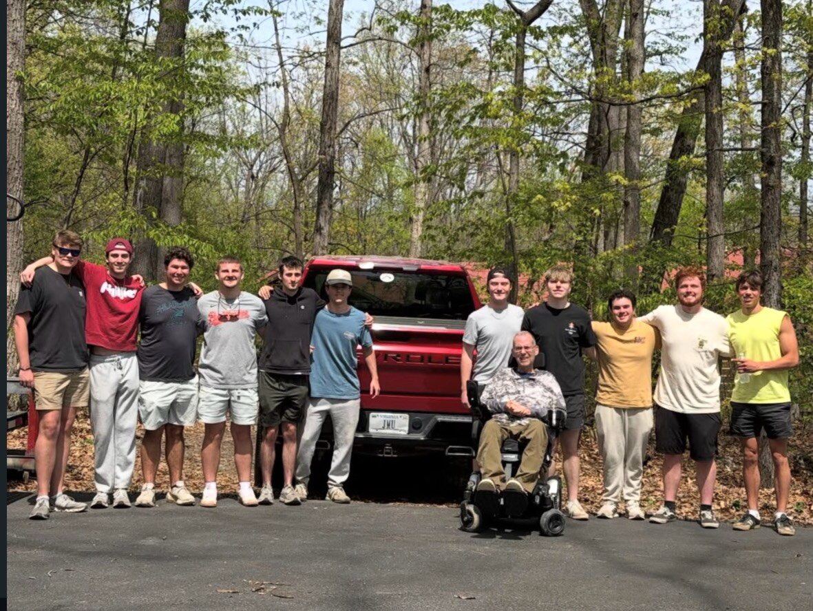 Brothers lined up in a driveway at a spring service day
