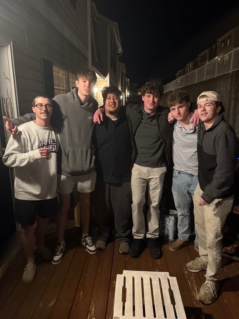 Brothers together on a deck at night