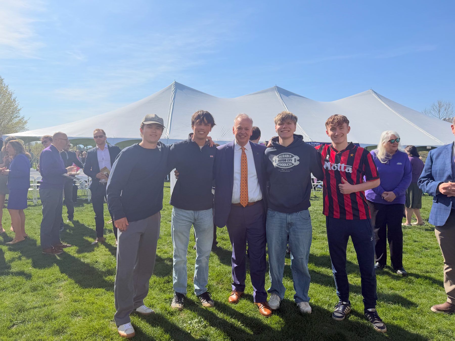 Brothers at an outdoor tent event