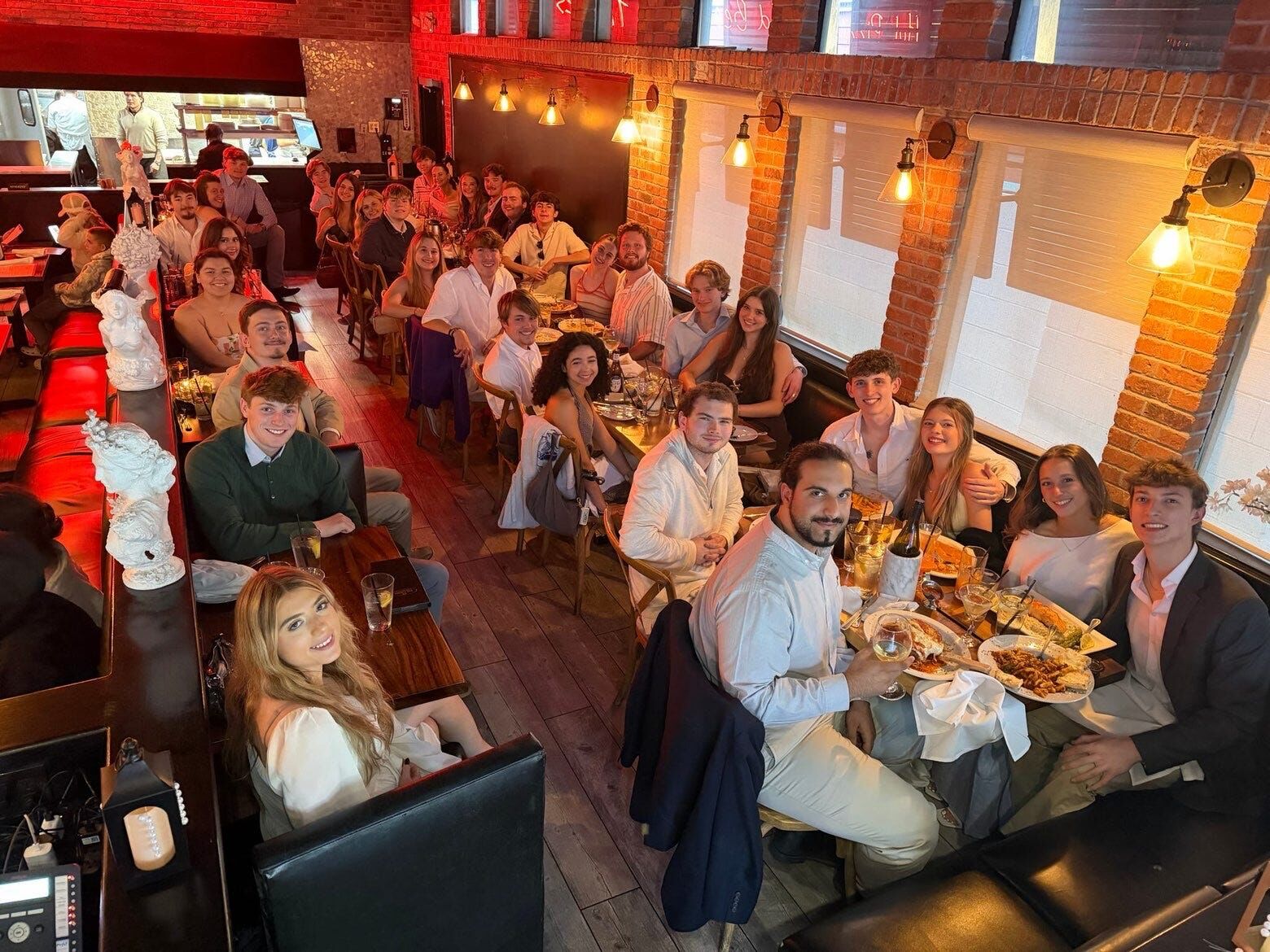 Brothers and guests at a restaurant dinner